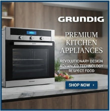 A Grundig built-in wall oven shown on a kitchen countertop with wood cabinetry behind it. The ad includes the text 'GRUNDIG PREMIUM KITCHEN APPLIANCES' and a blue 'SHOP NOW' button.
